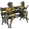Bronze musical kids playing on a bench