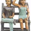 Bronze boy and girl on a bench