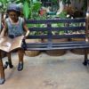Bronze girl reading on a bench