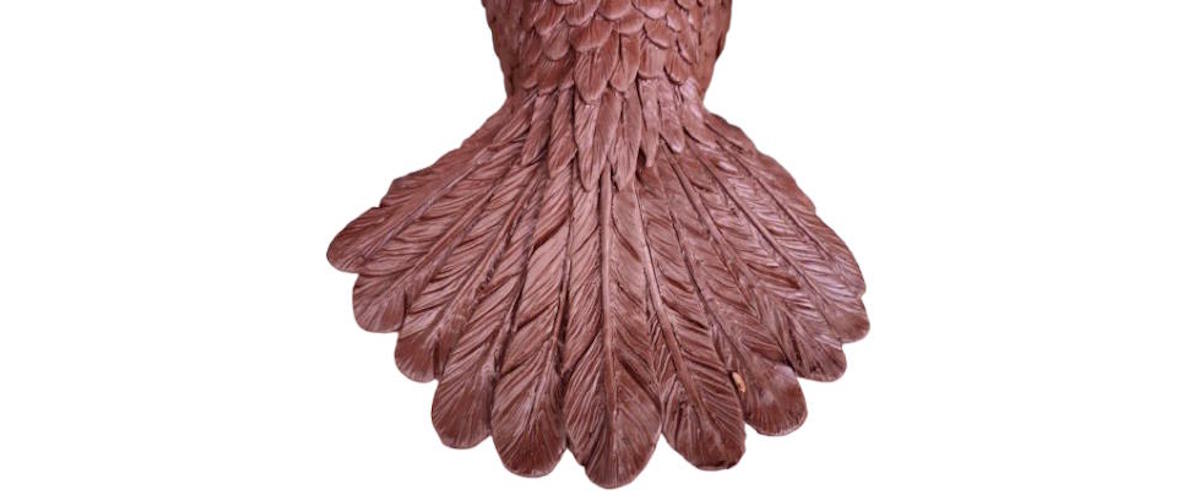 Hand-sculpted clay feathers on the Faribault High School bronze falcon before mold making