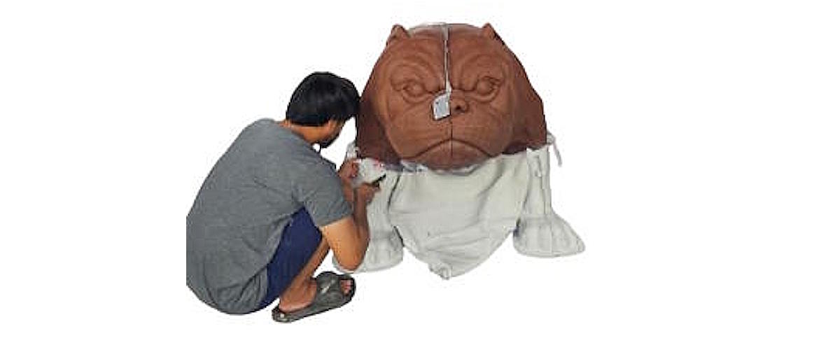 Artist sculpting the head of the Tracy High School bulldog mascot in clay