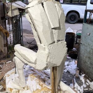 Front view of the Spartan Brigade monument during the early development stage, showing the sculpture divided into foam sections as it is prepared for the bronze casting process.