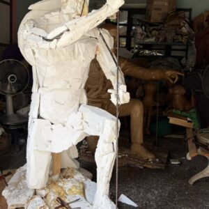 Front view of the Spartan Brigade monument during the early development stage, showing the sculpture divided into foam sections as it is prepared for the bronze casting process.