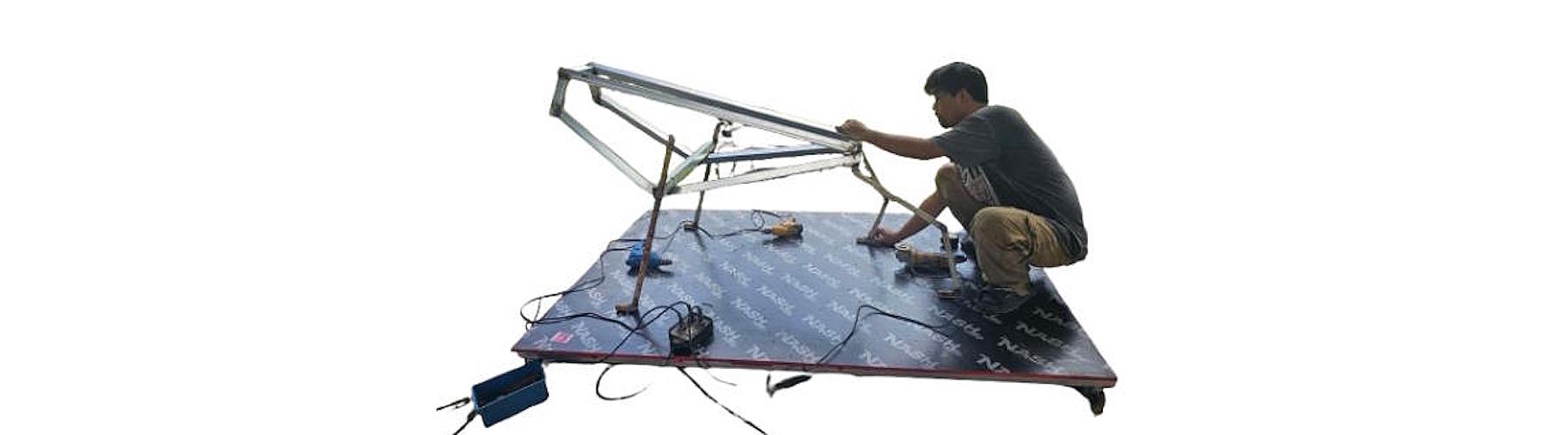 Artist welding the steel armature for the Tracy High School bulldog mascot sculpture