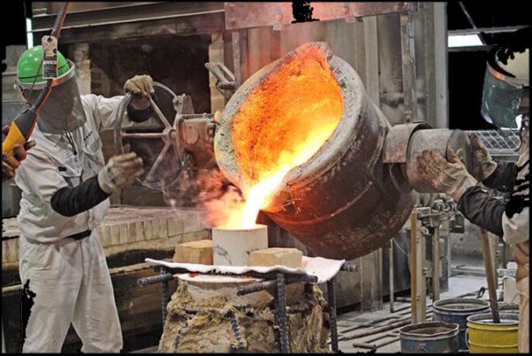 Molten bronze being poured into a ceramic shell mold during the traditional lost-wax bronze casting process.